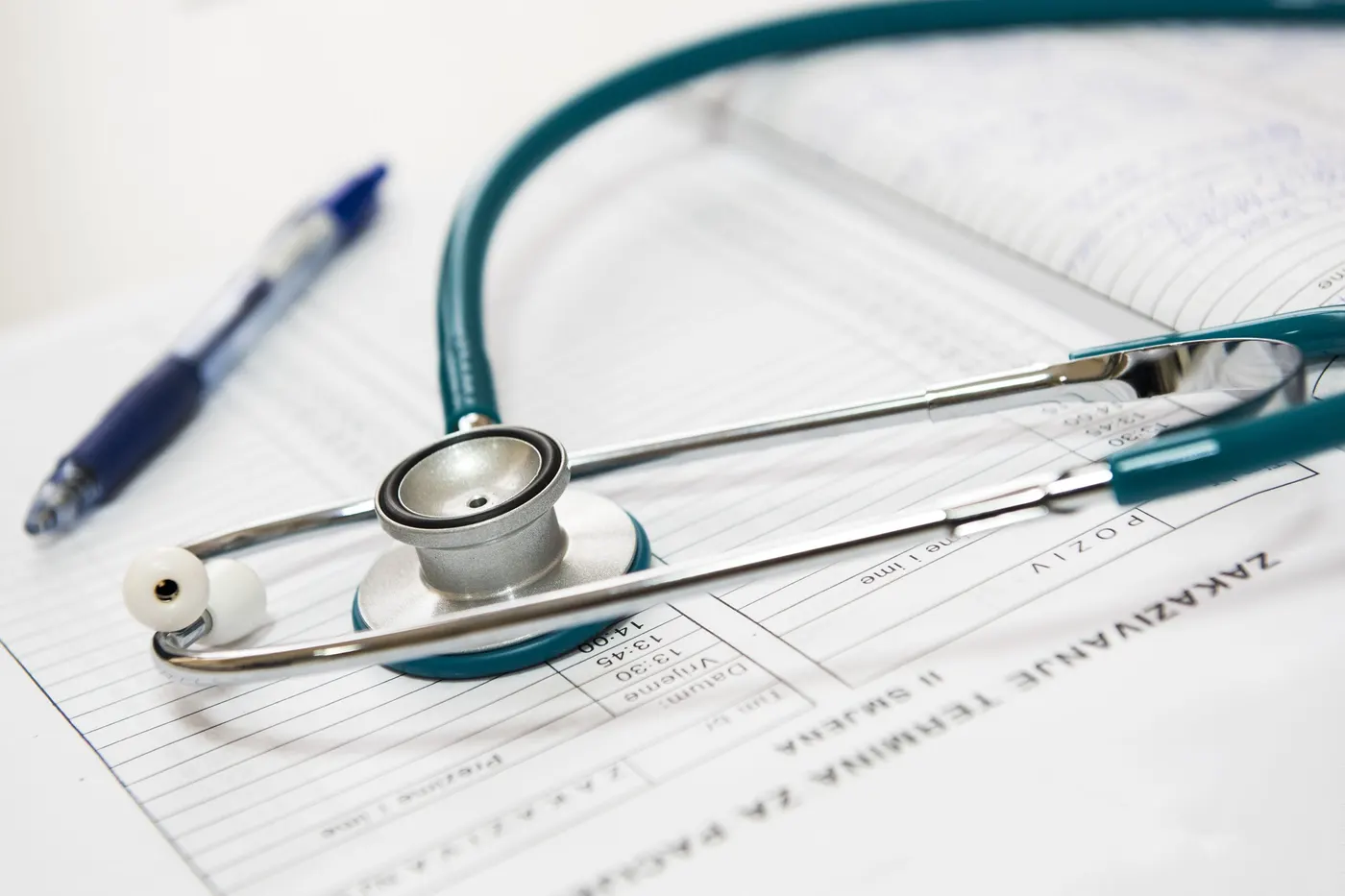 A stethoscope resting on medical forms
